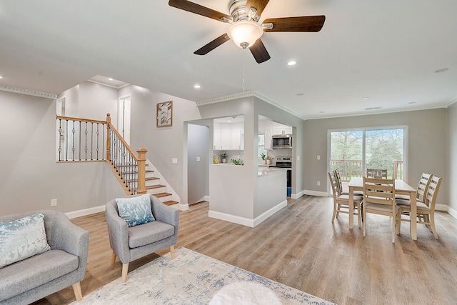 living room featuring light hardwood / wood-style floors, ceiling fan, and crown molding