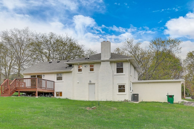 back of house featuring cooling unit, a deck, and a lawn