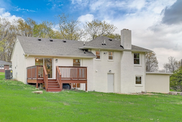 rear view of property with a lawn, cooling unit, and a deck