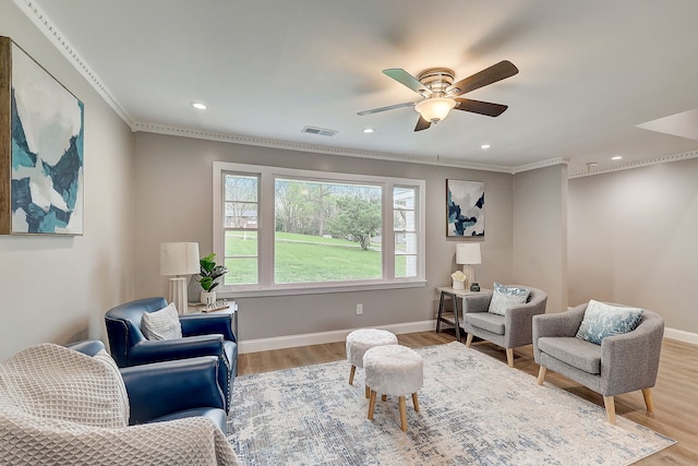 sitting room featuring crown molding, light hardwood / wood-style floors, and ceiling fan