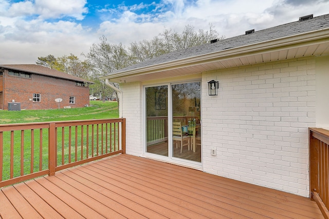 wooden terrace featuring central AC and a yard