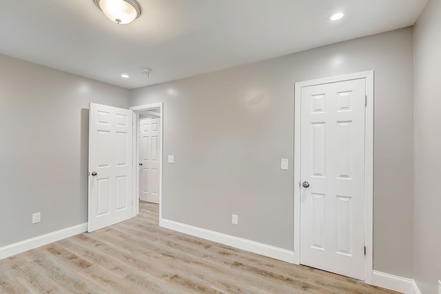 unfurnished room with light wood-type flooring