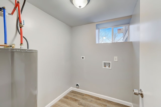 laundry area with hookup for a washing machine, water heater, light hardwood / wood-style floors, and electric dryer hookup