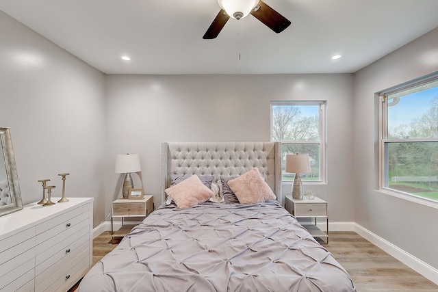 bedroom with ceiling fan and light hardwood / wood-style flooring