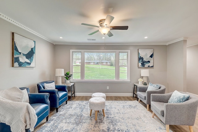 sitting room with ceiling fan, light hardwood / wood-style flooring, and ornamental molding