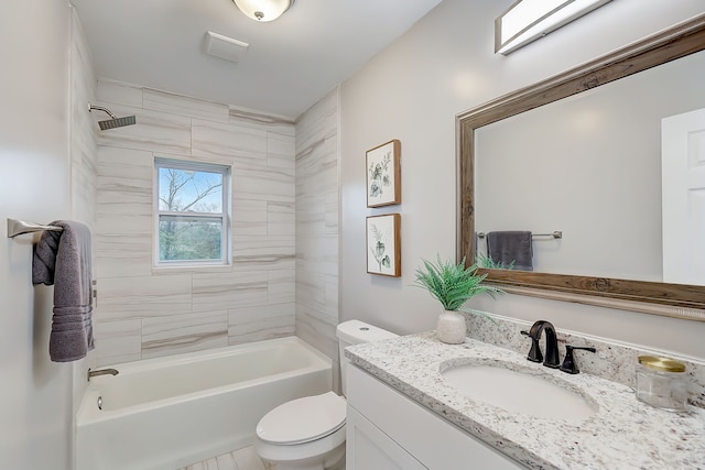 full bathroom featuring tiled shower / bath, vanity, and toilet