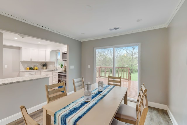 dining area with light hardwood / wood-style flooring and sink