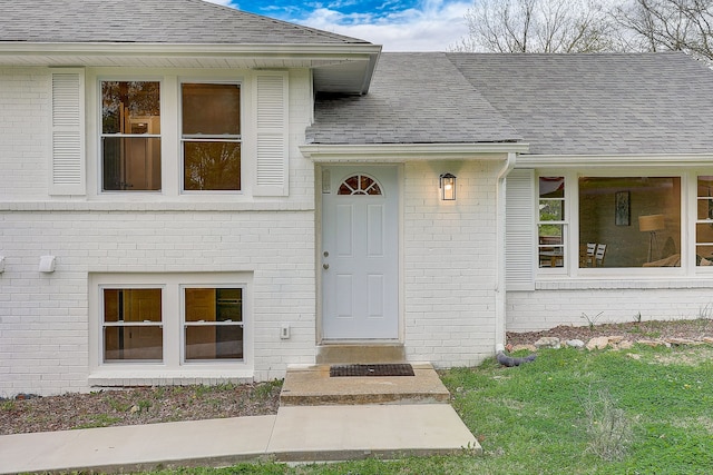 view of exterior entry with a lawn