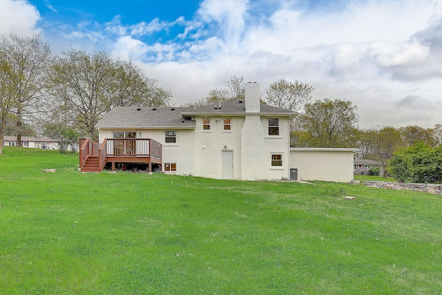 back of house featuring a deck and a yard