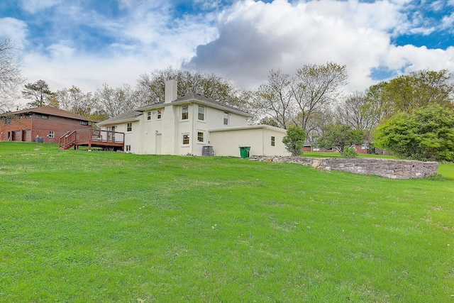 view of yard featuring a wooden deck and central air condition unit