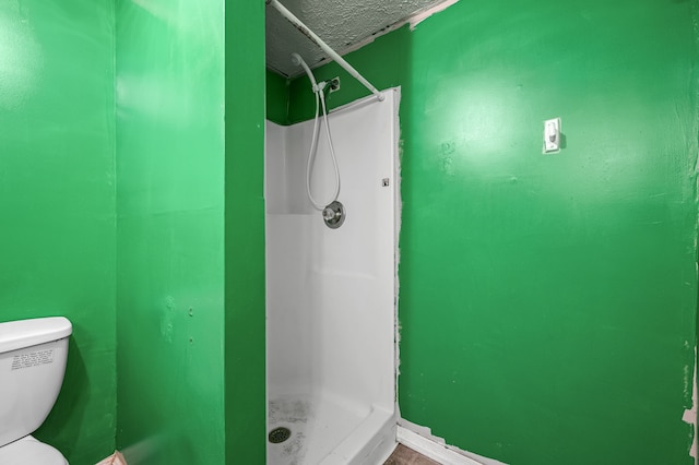 bathroom with walk in shower and toilet