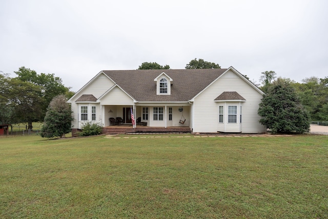 cape cod house with a porch and a front lawn