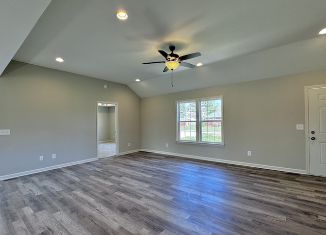 spare room featuring wood-type flooring, lofted ceiling, and ceiling fan