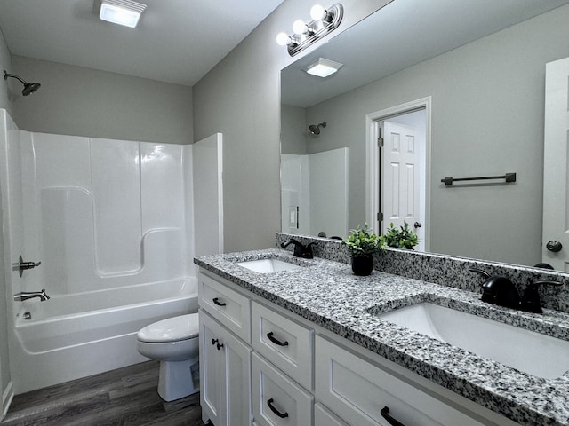 full bathroom featuring  shower combination, vanity, toilet, and hardwood / wood-style flooring