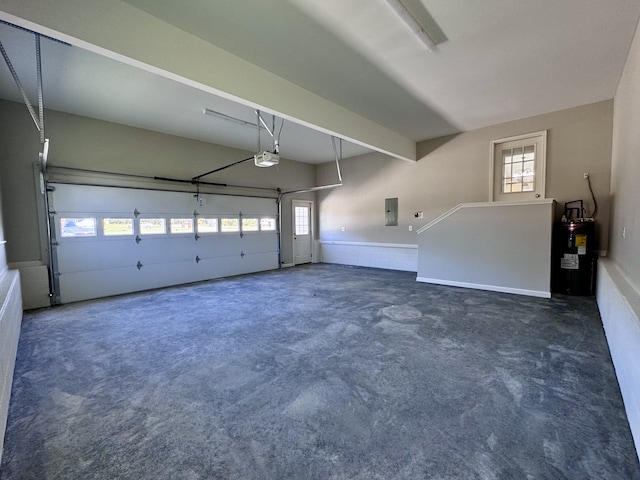 garage with a garage door opener, electric water heater, and electric panel