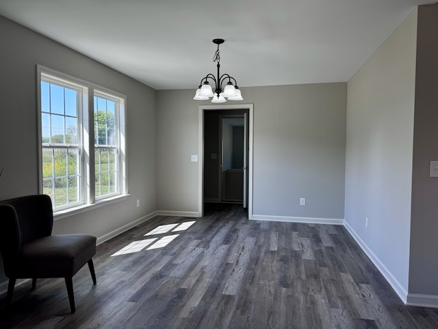 unfurnished dining area with dark hardwood / wood-style flooring and a notable chandelier