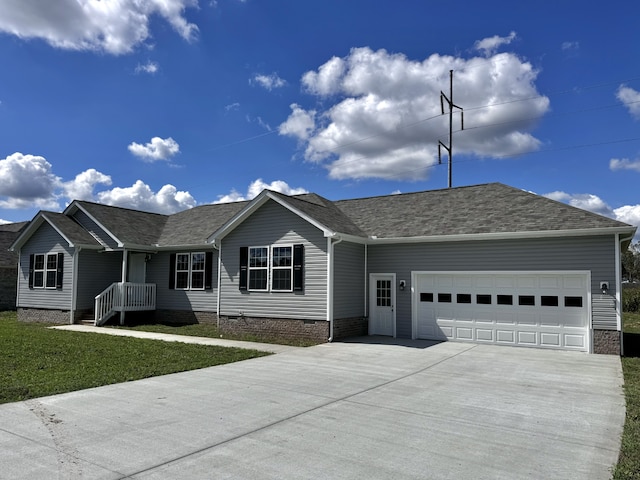 ranch-style home with a garage and a front lawn