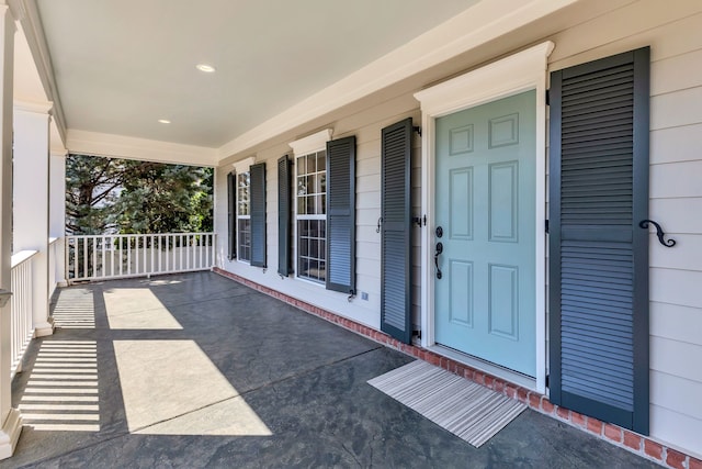 view of exterior entry featuring a porch