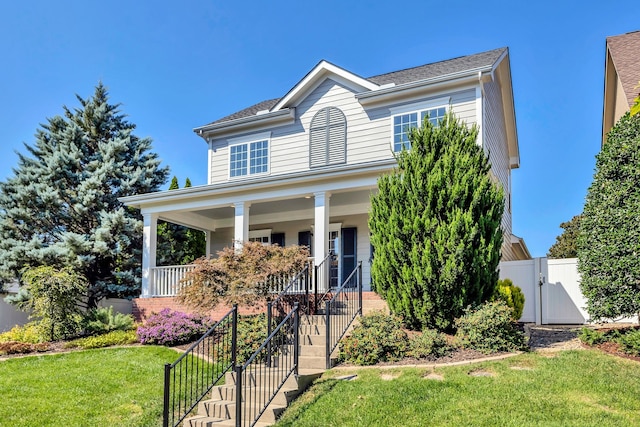 view of front of home with a porch and a front lawn