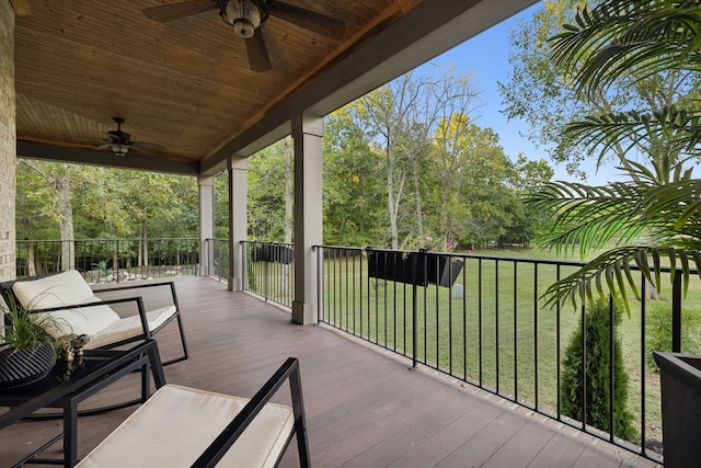 deck with ceiling fan and a yard