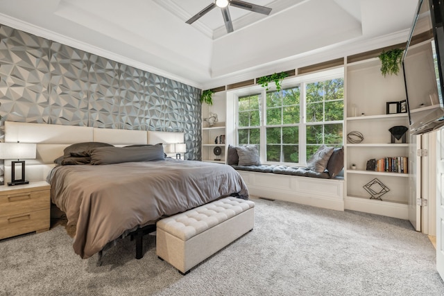 bedroom featuring ornamental molding, a tray ceiling, ceiling fan, and light colored carpet