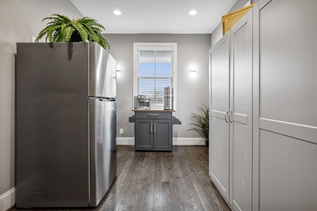 kitchen featuring dark hardwood / wood-style flooring, gray cabinetry, and stainless steel fridge