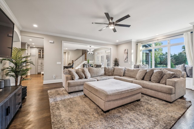 living room with crown molding, ceiling fan with notable chandelier, and dark hardwood / wood-style floors