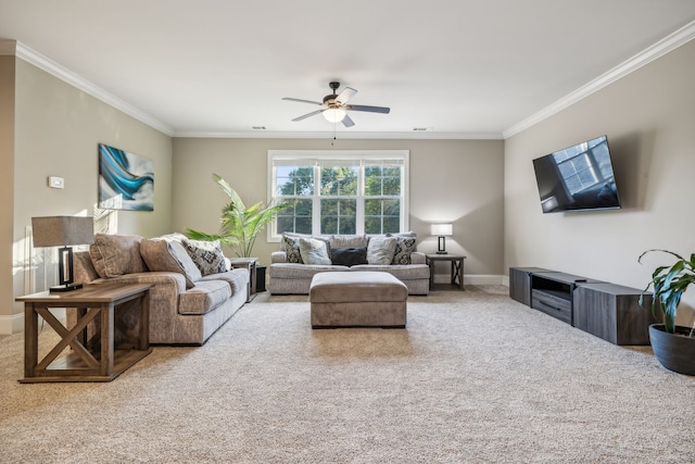 living room with ceiling fan, ornamental molding, and carpet