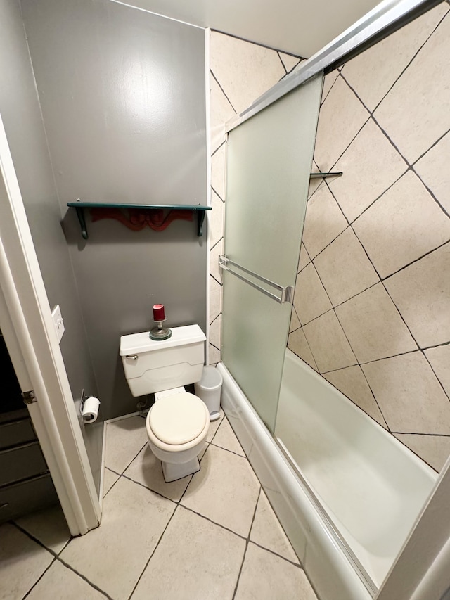 bathroom featuring tile patterned floors, a shower with shower door, and toilet