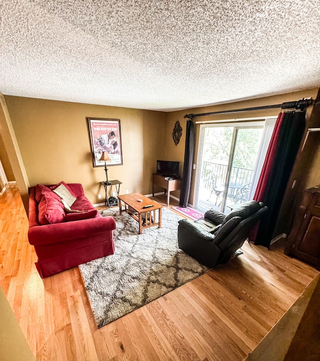 living room with a textured ceiling and hardwood / wood-style flooring