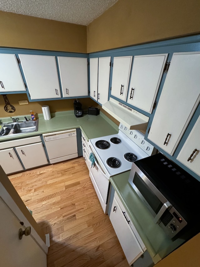 kitchen featuring a textured ceiling, white appliances, white cabinetry, and light hardwood / wood-style floors