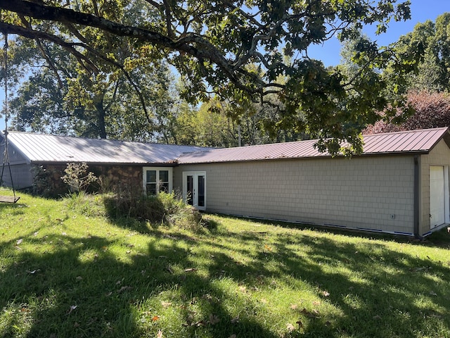 rear view of house featuring a lawn