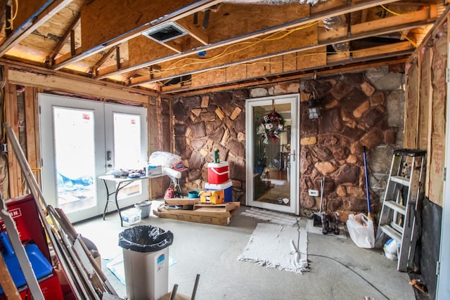 miscellaneous room featuring lofted ceiling and french doors