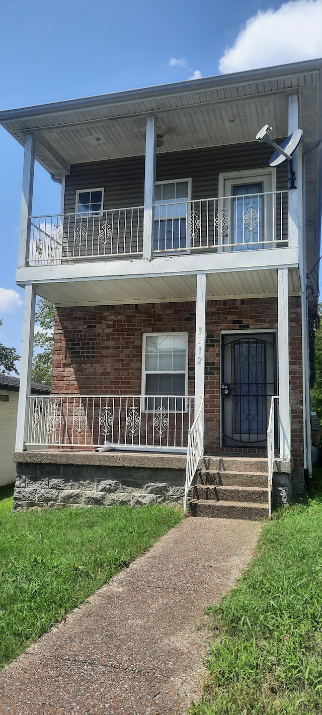 view of front of house with a balcony and covered porch