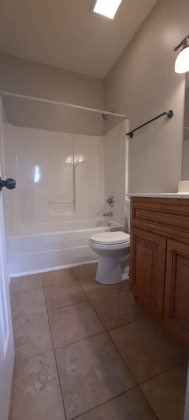 full bathroom featuring vaulted ceiling,  shower combination, tile patterned floors, vanity, and toilet