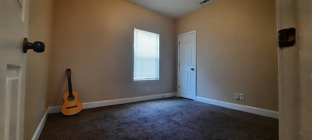 carpeted spare room featuring plenty of natural light