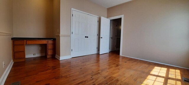 unfurnished bedroom featuring dark wood-type flooring