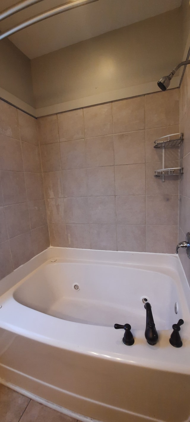 bathroom with tiled shower / bath combo and tile patterned floors