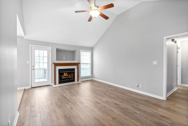 unfurnished living room with vaulted ceiling, ceiling fan, and hardwood / wood-style floors