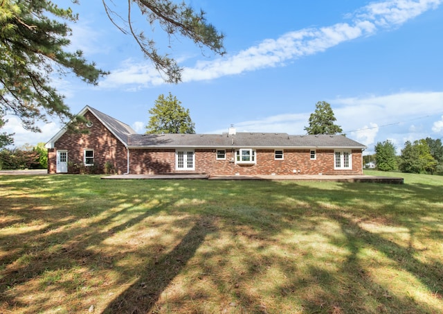 rear view of house with a lawn