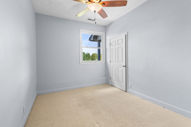 carpeted spare room featuring ceiling fan