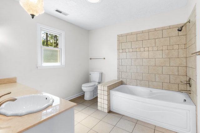 full bathroom with a textured ceiling, vanity, toilet, and tile patterned floors