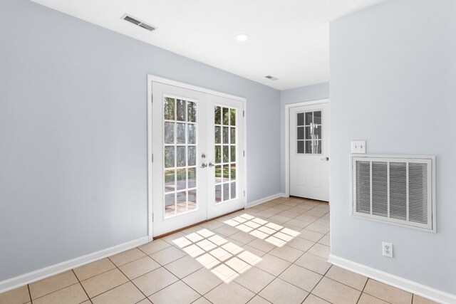 doorway with french doors and light tile patterned floors