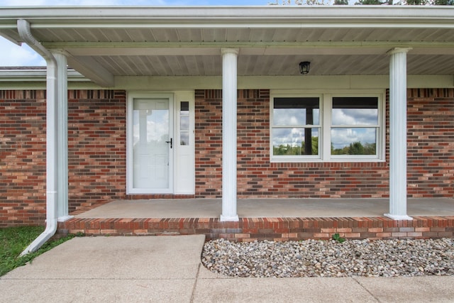 view of exterior entry with covered porch