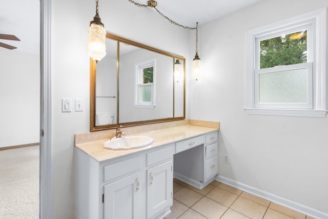 bathroom with tile patterned flooring, ceiling fan, plenty of natural light, and vanity