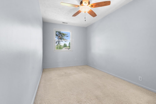 spare room featuring ceiling fan and light colored carpet