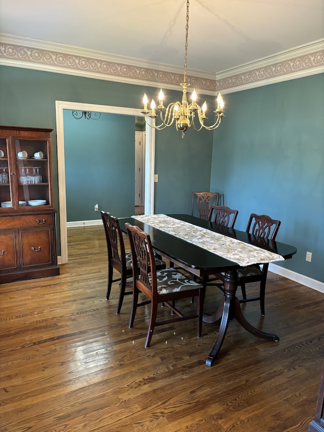 dining room featuring ornamental molding, a notable chandelier, and dark wood-type flooring