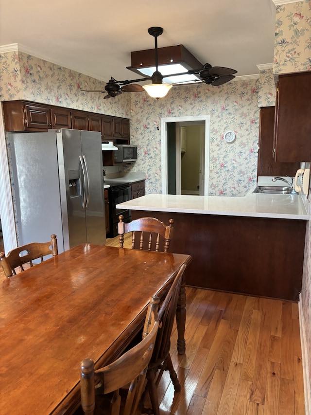 dining area with ornamental molding, light hardwood / wood-style floors, ceiling fan, and sink