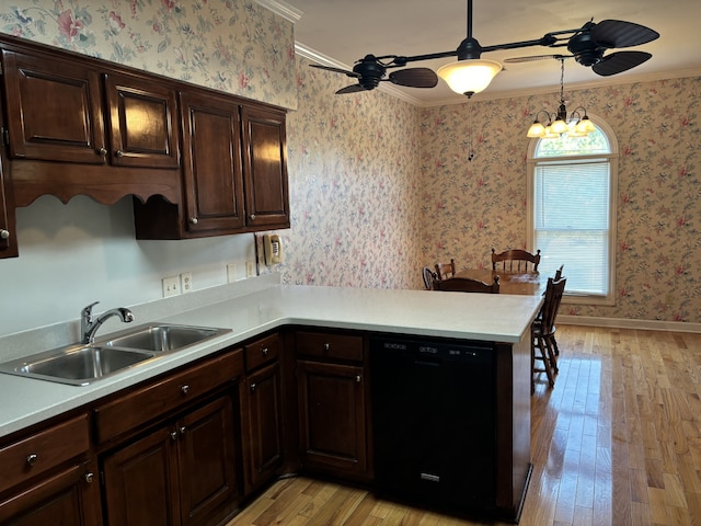 kitchen featuring pendant lighting, black dishwasher, light hardwood / wood-style floors, sink, and ornamental molding