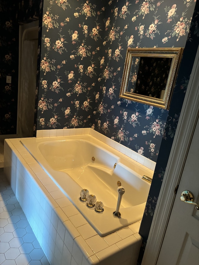 bathroom with tiled tub and tile patterned flooring